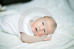 Newborn baby waking up in the crib