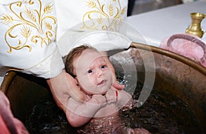 Newborn baby water baptism photo