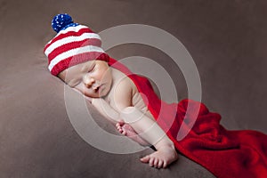 Newborn baby wearing a usa flag knitted hat