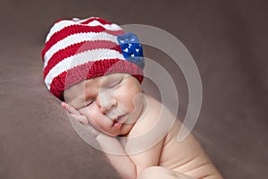 Newborn baby wearing a usa flag knitted hat