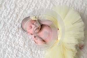 Newborn Baby Wearing a Yellow Tutu