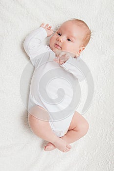 Newborn baby in white romper