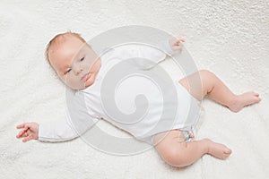 Newborn baby in white romper