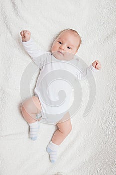 Newborn baby in white romper photo