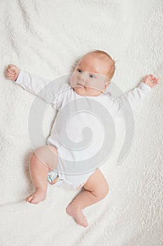 Newborn baby in white romper photo