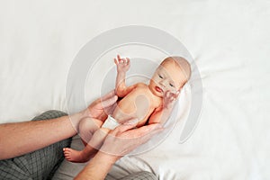 Newborn baby and young dad close up. Baby care concept, newborn weight, diapers, napkins, temperature, bilirubin