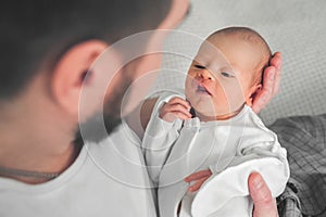 Newborn baby and young dad close up. Baby care concept, newborn weight, diapers, napkins, temperature, bilirubin