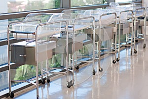 Newborn bassinets or beds in hospital hallway photo