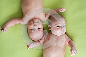 Newborn beautiful baby twins. Closeup portrait, caucasian child