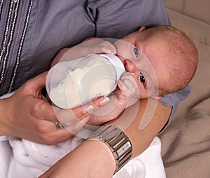 Newborn being bottle fed