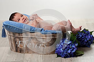 Newborn boy with blue flowers
