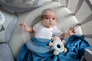 Newborn boy lies in a round bed