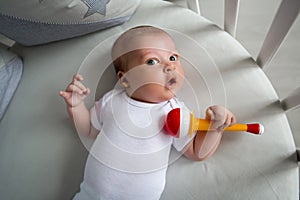 Newborn boy lies in a round bed