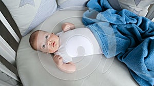 Newborn boy lies in a round bed