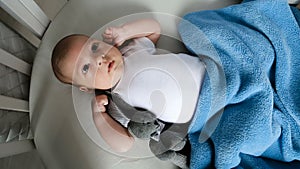 Newborn boy lies in a round bed