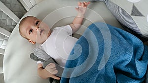 Newborn boy lies in a round bed