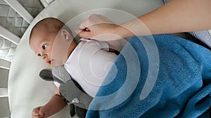 Newborn boy lies in a round bed