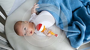 Newborn boy lies in a round bed