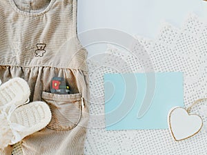 Newborn boy pants and baby booties on a white knitted background.