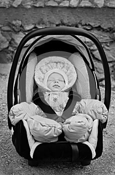 Newborn boy sleeping in the car seat