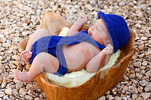 Newborn boy wearing blue fedora, tie, diaper cover