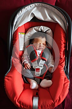 Newborn in car safety seat photo