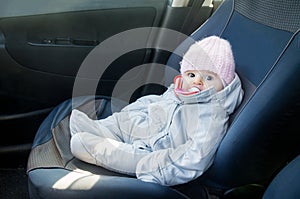 Newborn car sitting front seat dressed winter