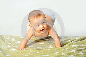 Newborn child relaxing in bed. Happy baby playing. Beautiful expressive adorable happy cute laughing smiling infant