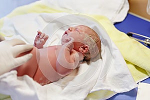 Newborn child seconds and minutes after birth. Check up