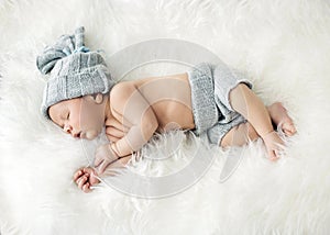 Newborn child sleeping on the blanket