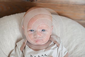 A newborn child with a sullen expression photo