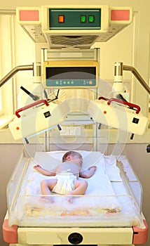 Newborn child under ultraviolet lamps