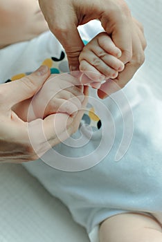 Newborn children`s hand in mother hand. Mom and her Child. Happy Family concept