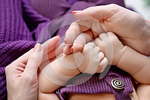 Newborn children's hands in mother hand. Mom and her Child. Happy