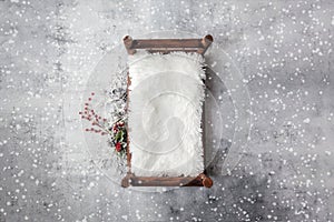 Newborn Christmas backdrop - wooden bed with white faux fur, snow covered branches with red berries on white background