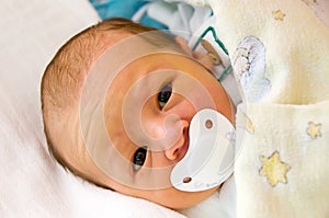 Newborn with dummy - pacifier photo