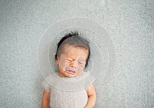 Newborn frown and start to cry with expressing a feeling of hunger for mother`s milk