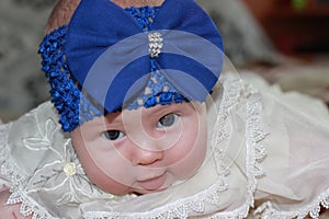 Newborn girl with big blue bow