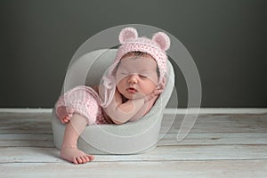 Newborn Girl Wearing a Pink Bear Hat