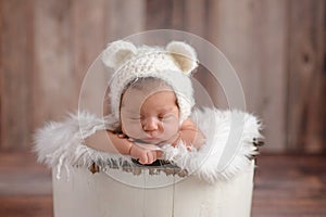 Newborn Girl Wearing a White Bear Hat