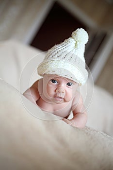 Newborn girl in white cap