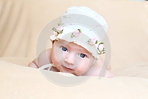 Newborn girl in white cap with flouwers