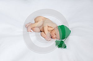 Newborn in green knitted hat