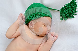 Newborn in green knitted hat