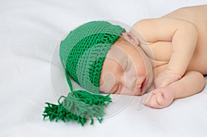 Newborn in green knitted hat