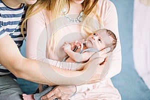 Newborn on hands at mum and dad photo