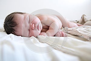 Newborn infant baby portrait first day life sleeping on diapers