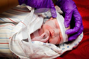 Newborn Infant Getting His Head Measured