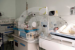 Newborn innocent baby sleeping in an incubator