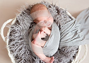 Newborn kid in nest bed